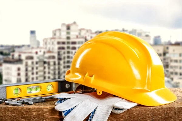 Construction tools and helmet on building construction background