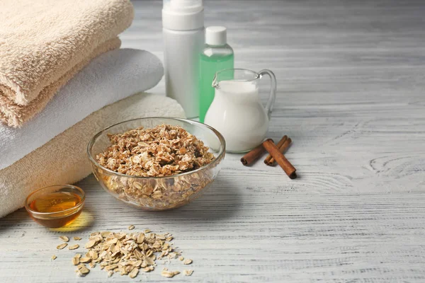 Body scrub, honey and cosmetics on wooden background