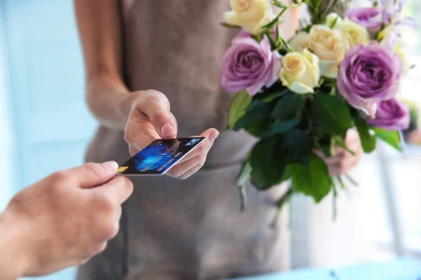 Customer giving credit card to florist