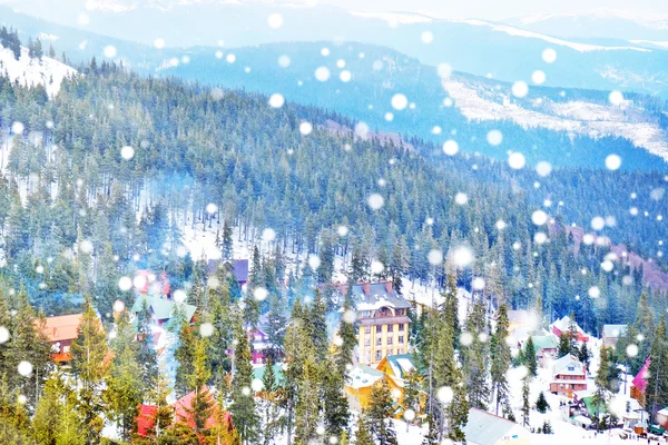Winter resort in mountain forest. Beautiful landscape, snowy effect.