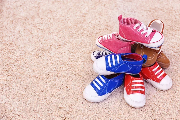 Colorful kids shoes on floor