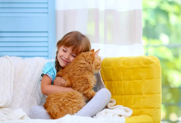 Cute little girl and red cat