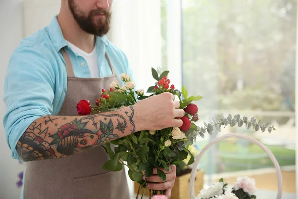 Tattooed florist with beautiful flowers