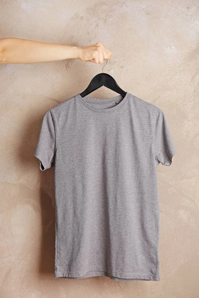 Gray t-shirt against grunge wall