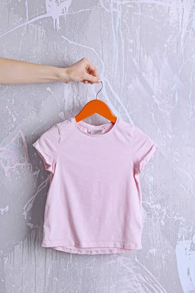 Pink t-shirt against grunge wall