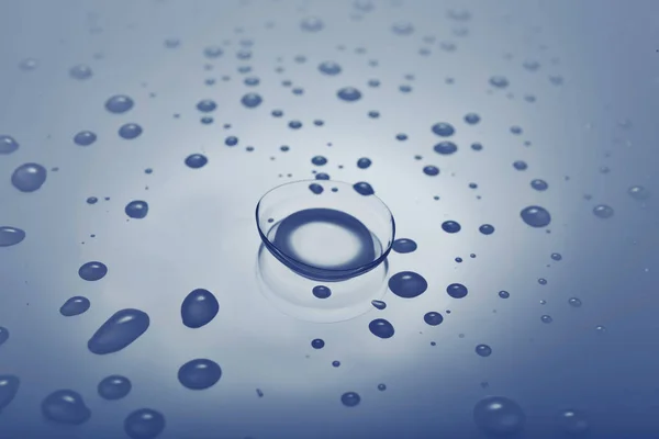 Contact lens on smooth wet background