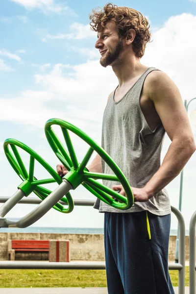 Active man exercising with tai chi wheel.