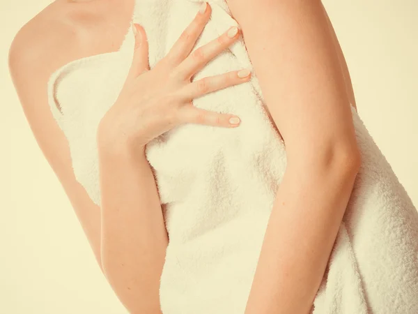 Woman covering breast under towel.