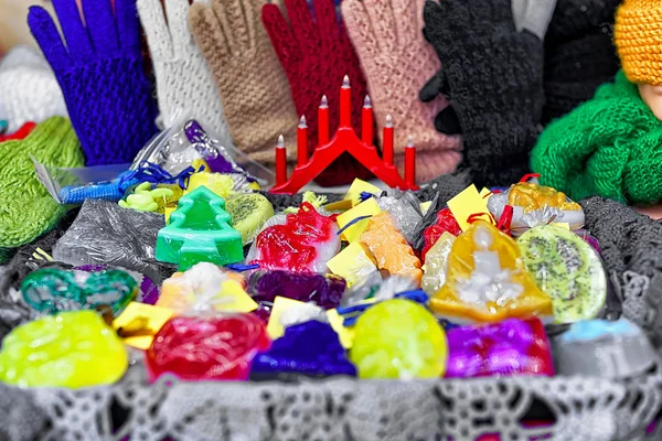 Handmade colorful soap among knitted gloves at Riga Christmas market