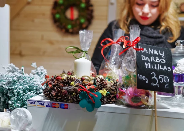 Woman selling handmade soap on Vilnius Christmas Market in Lithu