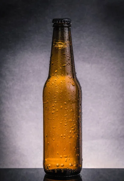 Fresh cold beer ale bottle with drops and stopper