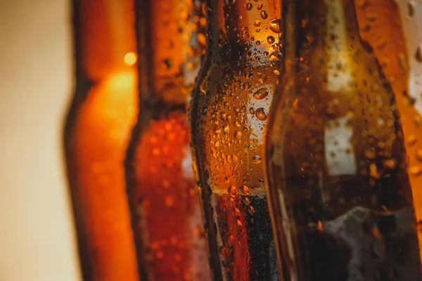Close-up of fresh cold beer ale bottles with drops and stopper