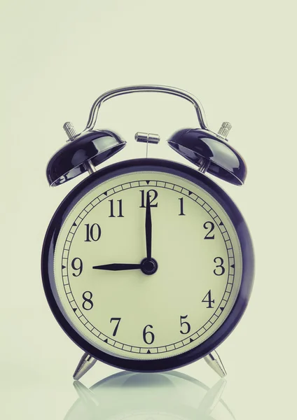 It\'s nine o\'clock already, time to wake up for breakfast, vintage old black metallic alarm clock