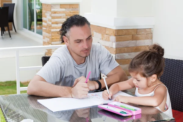 Dad and daughter draw together