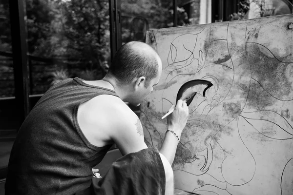 Male artist painting a picture