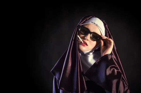 Portrait of a smoking young nun