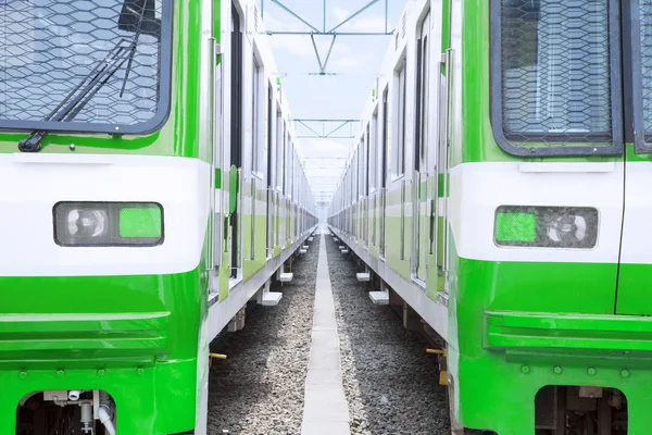 Two green electric trains