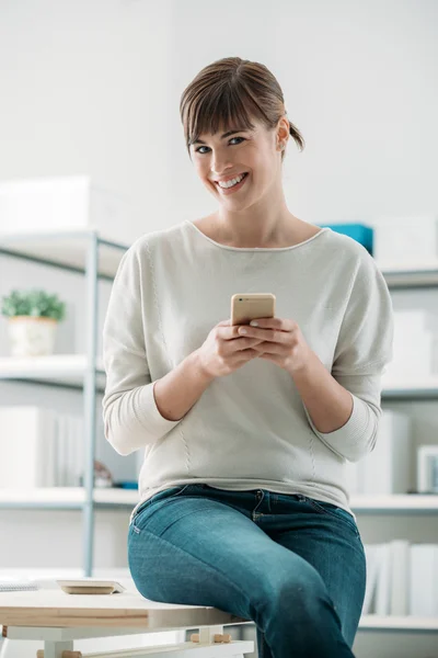 Smiling woman using a smart phone