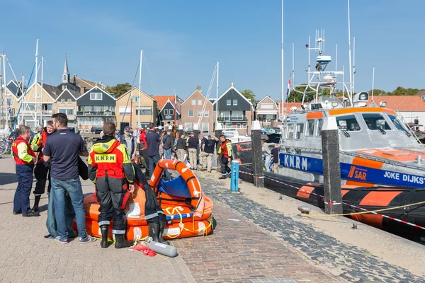 Rescue workers showing rescue equipment in Dutch harbor of Urk