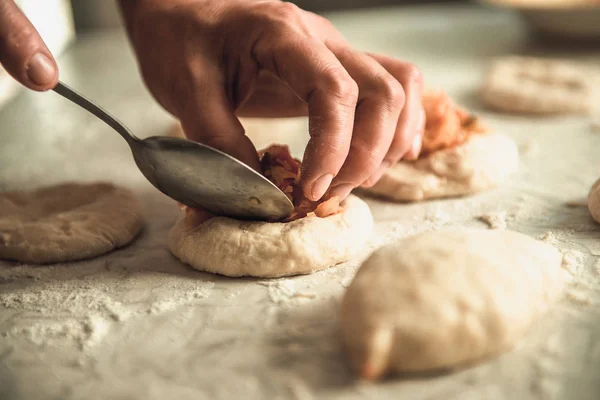 Homemade cakes of the dough in the women\'s hands