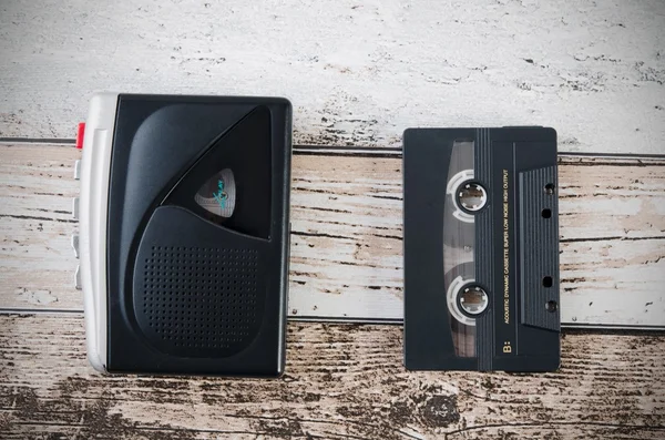 Old tape player, recorder and casette on wooden background