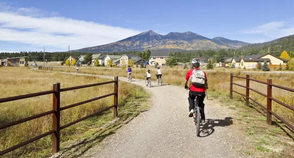 A Cyclist Family Rides in the Fall