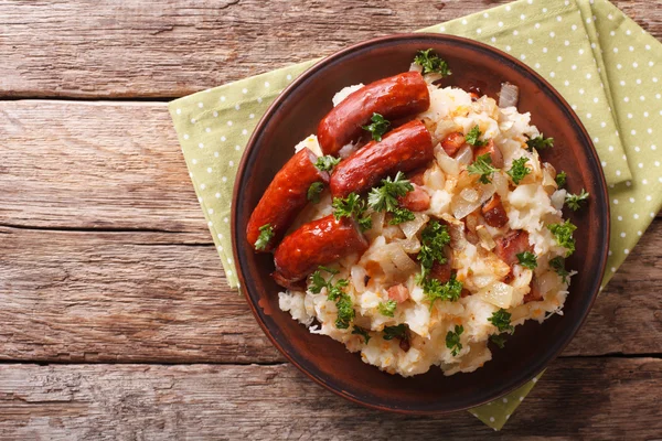 Dutch stamppot of potatoes, cabbage and carrots, with sausages c