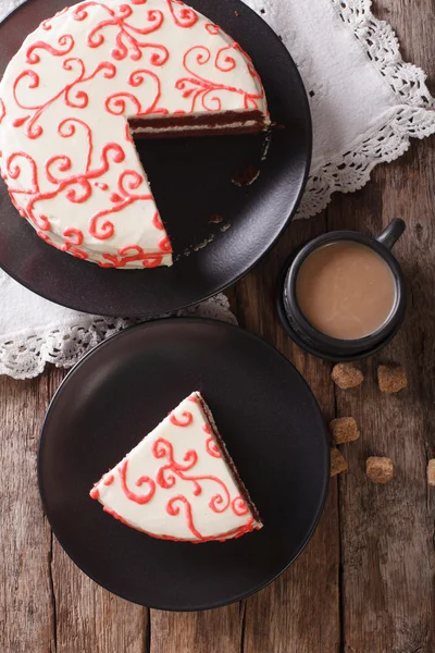 Sliced festive red velvet cake and coffee close-up on the table.