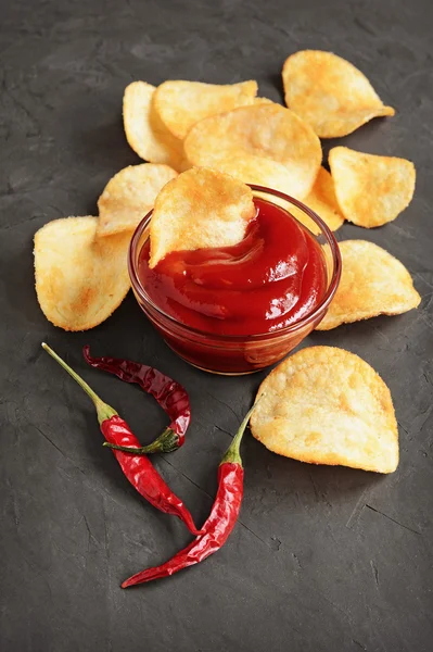 Potato chips and red pepper sauce
