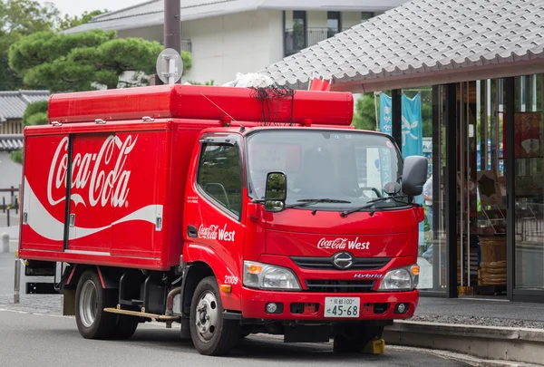 Coca-Cola delivery truck in the street.