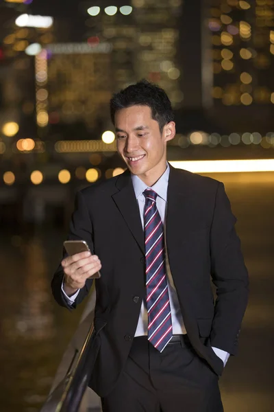 Chinese businessman using smartphone