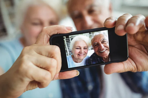 Senior couple taking photo from phone