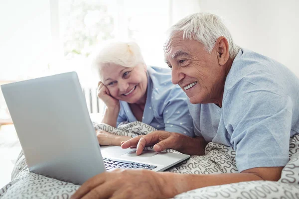 Senior couple using laptop