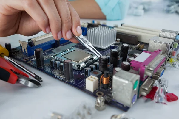 Computer engineer repairing computer motherboard