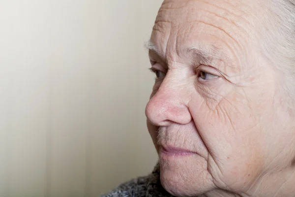 Portrait of an elderly woman on a light background