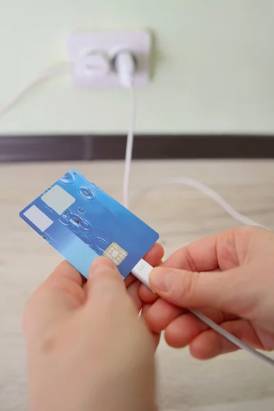 Concept hands holding card for charging