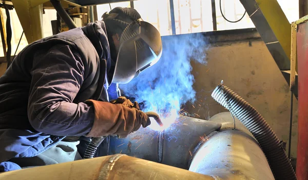 Woman welder welding