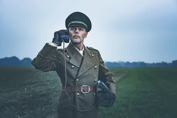 Military officer calling with field phone