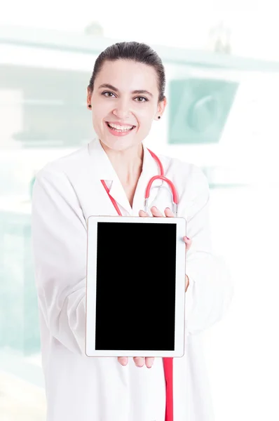 Trustworthy medical specialist holding modern tablet