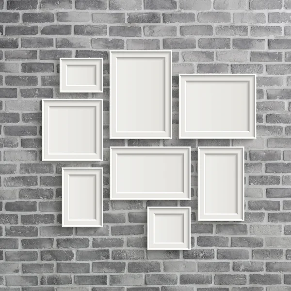 Blank frames on grey birck wall