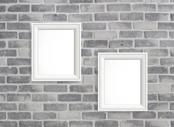 Blank frames on grey birck wall