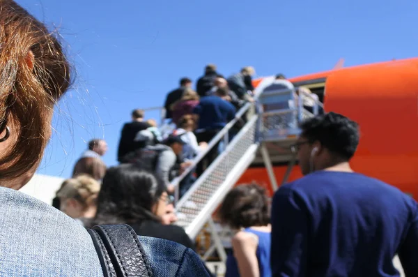 Passengers boarding airplane