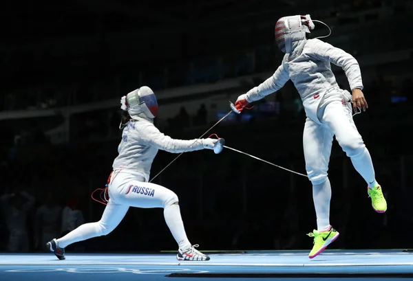 Ibtihaj Muhammad of United States (R) and Sofya Velikaya of Russia compete in the Womens Sabre Team of the Rio 2016 Olympic Games