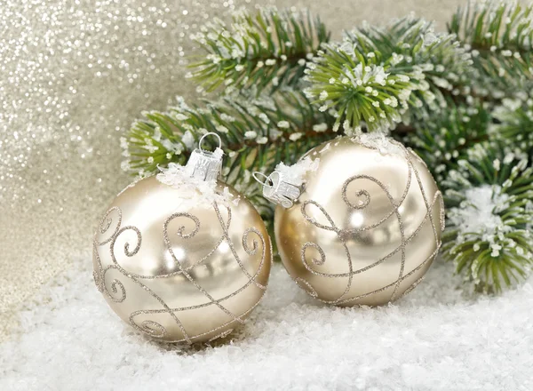 Golden baubles with christmas tree branches