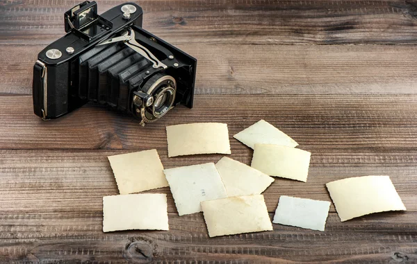 Vintage photo camera and old paper photos