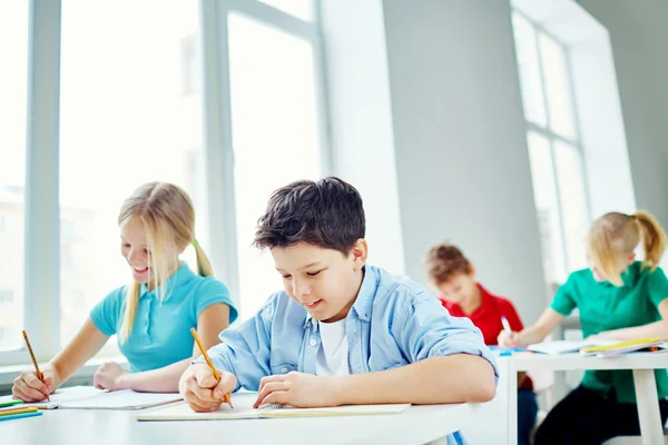 Schoolchildren writing test at lesson