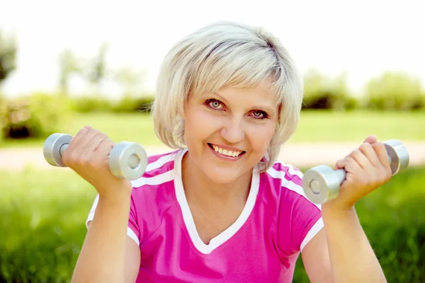 Mature woman with dumbbells