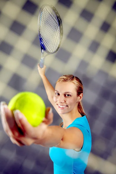 Pretty tennis player serving a ball