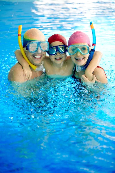 Happy family in water with scuba masks