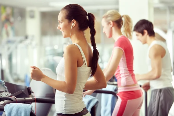 Group of people training on treadmill